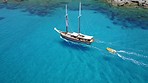 Travel, landscape and boat in ocean for cruise, holiday and summer vacation on island in Mauritius. Sailing transport, sea and aerial drone view of yacht for tropical adventure, freedom and traveling