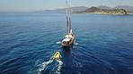 Travel, water and boat in ocean for cruise, holiday and summer vacation on luxury transport. Sailing, sea landscape and aerial drone view of yacht for tropical adventure, freedom and island traveling