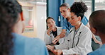 Doctors, nurse and women on clipboard in meeting, collaboration or teamwork for hospital planning, medical or life insurance. Talking, leadership and healthcare workers on paper in diversity research