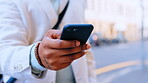 Hands, phone and typing in city for social media, texting or web scrolling outdoors in street. Technology, cellphone and black man using 5g mobile smartphone for internet browsing and networking.