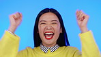 Asian woman, portrait and excited with hands for celebration, win or sale on a blue background. Happy model person cheering for news announcement, promotion deal or competition winner in studio