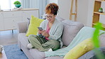 Black woman, phone and typing on couch for social media post, funny internet meme or mobile app chat. Young person laughing, relax on sofa and smartphone or cellphone networking in her living room