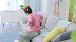 Health, back pain and woman on couch, stress and muscle strain in living room, burnout and body care. Medical, female or lady on sofa, tension or inflammation with bruise, fatigue or injury in lounge