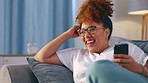 Black woman, phone and thinking about funny meme on home couch for communication or online chat. Happy model person laughing with smartphone on living room sofa for social media post, video or idea