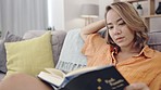 Woman, religion book and reading in living room for study, faith and focus for mindfulness in home. Gen z girl, worship or spiritual story for calm, peace or novel for learning, studying or thinking