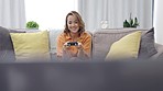 Asian woman, gaming controller and sofa in home living, happy and excited focus on competition. Gen z girl, esports and video game contest on internet to relax on lounge couch with happiness in house