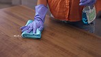 Woman, hands and cleaning wooden table with detergent for housekeeping, hygiene or disinfection at home. Hand of female cleaner spraying clean chemical for dirt removal, sanitizing or wiping table