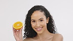 Woman, beauty and orange fruit portrait for skincare in studio with vitamin c dermatology cosmetic. Aesthetic model person on white background with healthy food for self care, facial and natural glow