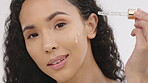Black woman, face and oil serum for beauty, facial and skincare, dropper with hyaluronic acid on studio background. Portrait, cosmetic product with liquid collagen, glow and shine with dermatology