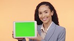 Black woman, tablet and green screen mockup for advertising or marketing against a studio background. Happy African American female showing touchscreen display or chromakey for advertisement or brand