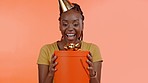 Black woman open birthday present, gift box and smile on wow face on studio background. Happy female model opening package for celebration, happiness or celebrate special excited event with party hat