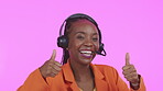 Call center, customer service and thumbs up with a black woman consultant in studio on a pink background. Portrait, contact us and hand gesture with a happy female consulting using a headset