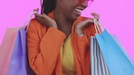 Closeup, black woman and bags with retail, boutique items and female customer against a studio background. Zoom, African American lady and client with expensive clothes, purchase or fashion with sale