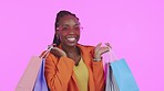 Black woman, shopping bag and studio with excited face for online sale, happy and clothes by purple background. African gen z girl, smile and portrait for retail discount, store deal and fashion