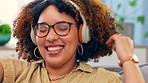 Music, dance and black woman on a sofa with headphones happy, smile and having fun in her home. Radio, podcast and girl dancing to online audio, track and playlist in a living room, carefree and joy