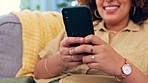 Hands, phone and black woman laughing on sofa for social media, text or meme in her home. Online, comic and girl relax with smartphone on couch, chatting or reading post or update in a living room