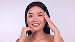 Skincare, facial and Asian woman touch face for wellness, cosmetics and beauty products in studio. Dermatology mockup, spa aesthetic and portrait of happy girl for healthy skin, glow and self care