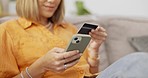 Cellphone, credit card and lady on a sofa doing online shopping on website retail store. Technology, ecommerce and hands of woman paying bills with internet banking on a phone in living room at home.