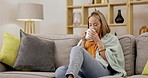 Asian woman on couch, coffee and relax with peace, inspiration and motivation in living room. Japan, female and lady with tea, blanket and resting on sofa, calm and break for self care and chilling