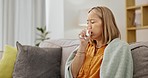 Asian woman on couch, sneeze and cough with tissue, health and suffering in living room with blanket. Female, lady and illness with toilet paper, allergy and virus in lounge, sofa and flu symptoms