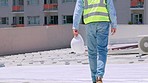 Legs, engineering or architect walking on roof  on construction site planning real estate building. Contractor, zoom or black man working on renovation business in project management outdoors in city