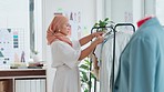 Fashion, quality assurance and muslim woman with clothing in store, checking stock and product design. Small business, startup and young islamic designer in hijab clothes on rail and inventory check.