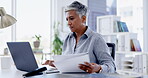 Laptop, documents and review with a business woman at work in her office for a proposal or report. Computer, reading and paperwork with a female employee working on her portfolio for company growth