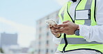 Black man, hands and phone in the city for construction planning, communication or social media on site. Hand of African American male contractor or engineer texting on smartphone on rooftop in town