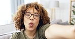 Black woman, selfie and silly face of a young person on a living room sofa with happiness. Portrait, influencer and smile of a female on a home couch taking a profile picture on social media 