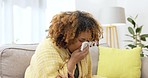 Black woman, sneeze and tissue in home for flu, healthcare and sick with blanket on living room couch. African girl, wellness and safety with blowing nose, toilet paper and allergy on lounge sofa