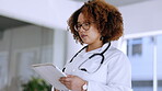 Black woman, doctor and tablet in healthcare research, browsing or scrolling for information at hospital. African American female medical expert working on touchscreen for medicare search at clinic