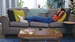 Woman, lying and relax on house sofa in calm, peace or zen mindset on comfort furniture, lounge couch or home seating. Smile, happy and person with hands behind head in living room for rest or break