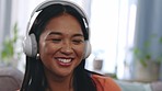 Smile, headphones and asian woman in living room dancing, excited and happy with online streaming radio service. Listening to music, dance and gen z girl on sofa enjoying song at home in Indonesia.