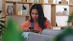 Woman, sad and phone on home sofa while typing and thinking about breakup, news or online chat. Asian girl with smartphone on lounge couch for communication, problem or reading upset email on app