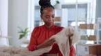 Black woman, designer and fabric for fashion in studio with delivery, logistics or boxes in workplace. Design expert, material inspection and texture check for vision, pattern and clothes in workshop