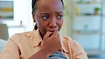 Crying, sad and black woman at home with depression and thinking with grief and stress. Mental health problem, burnout and depressed emotions of a young person with tears and distress in living room