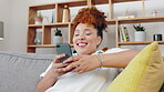 Phone, relax and woman texting on social media smile and laughing  at a funny meme in a home, house or apartment. Young, internet and person chatting on mobile app, website or web and happy