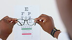 Optometry, letter and healthcare with glasses and chart and doctor for focus, reading and eye test. Medical, optics and text with hands of black person and spectacles for myopia, sight and vision