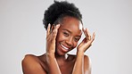 Skincare, portrait and black woman touching face isolated on a grey studio background. Beauty, smile and African girl feeling soft, glowing and clear facial skin from dermatology with mockup space