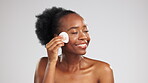 Skincare, cotton pad and black woman isolated on studio background for face or facial cleaning product promotion. Young model or person with beauty glow, cosmetics wipe and makeup in studio mockup