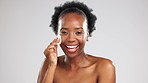 Face, skincare and smile of black woman with cotton in studio isolated on a gray background. Portrait, laughing and happy female model with facial pad for cleaning makeup cosmetics for healthy skin