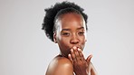 Skincare, face and black woman blowing kiss in studio isolated on a gray background. Portrait, makeup cosmetics and laughing female model blow air kisses for self love, romantic smile and beauty.