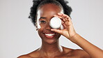 Face, skincare and black woman with cream container in studio isolated on a gray background. Dermatology portrait, cosmetics and laughing happy female model with lotion, creme or moisturizer product.