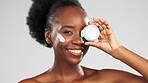 Skincare, face and black woman with cream container in studio isolated on a gray background. Dermatology portrait, cosmetics and laughing happy female model with lotion, creme or moisturizer product.