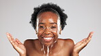 Face, skincare smile and black woman with water splash in studio isolated on gray background. Cleaning hygiene, portrait and happy female model bathing or washing for facial wellness and healthy skin