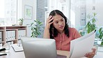 Asian woman, laptop and confused and thinking with documents in planning or strategy on office desk. Female employee in thought or wondering with paperwork on computer for project plan or idea