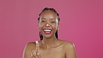 Black woman, face or laughing and beauty cream on isolated pink background for healthcare, wellness or skincare grooming. Smile, portrait or funny model and product, facial lotion or makeup cosmetics