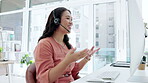 Asian woman, call center and consulting in telemarketing, customer service or support at office desk. Happy and friendly female consultant or agent talking with headset explaining sales in contact us