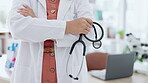 Hands, stethoscope and healthcare with a doctor woman in the hospital, standing arms crossed for cardiology. Heart, medical and insurance with a female medicine professional in a clinic for insurance