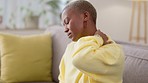 Stress, strain and black woman with neck pain from burnout, accident or fatigue on the sofa. Massage, tired and African girl feeling a painful muscle, inflammation problem or pressure on her back